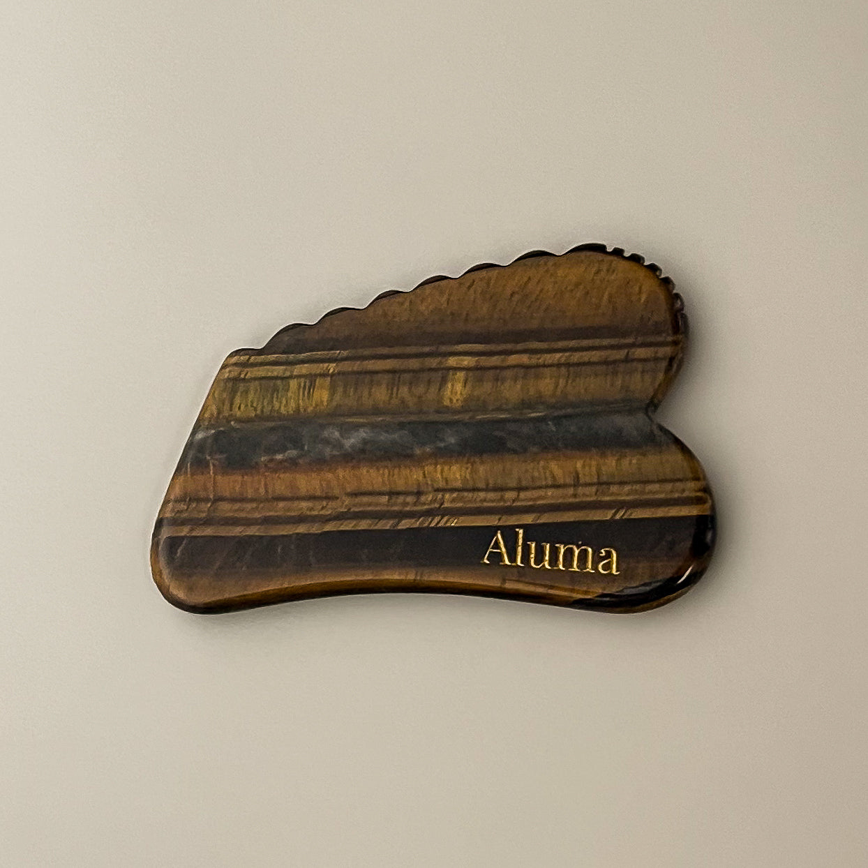Aluma Ori gua sha i tiger eye stone.